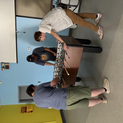 Paul, Alex, and Mark Playing Foosball